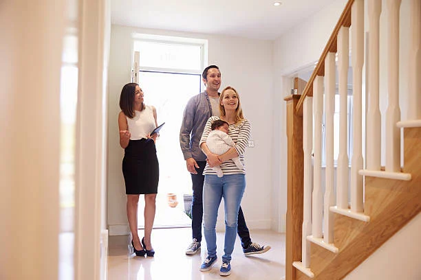 Couple looking at house with baby